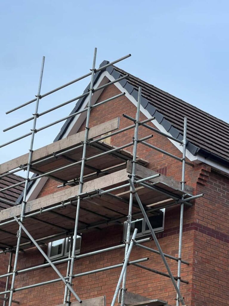 This is a photo of a roof which has just been repaired. There is a scaffold located at the gable end for access onto the roof. Works carried out by Countesthorpe Roofing Repairs